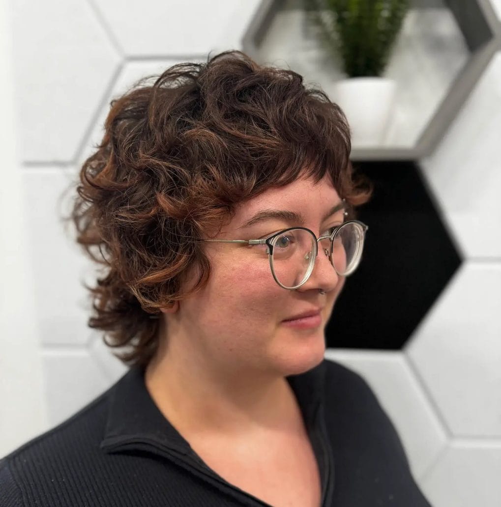 Defined curls in pixie with subtle highlights and glasses