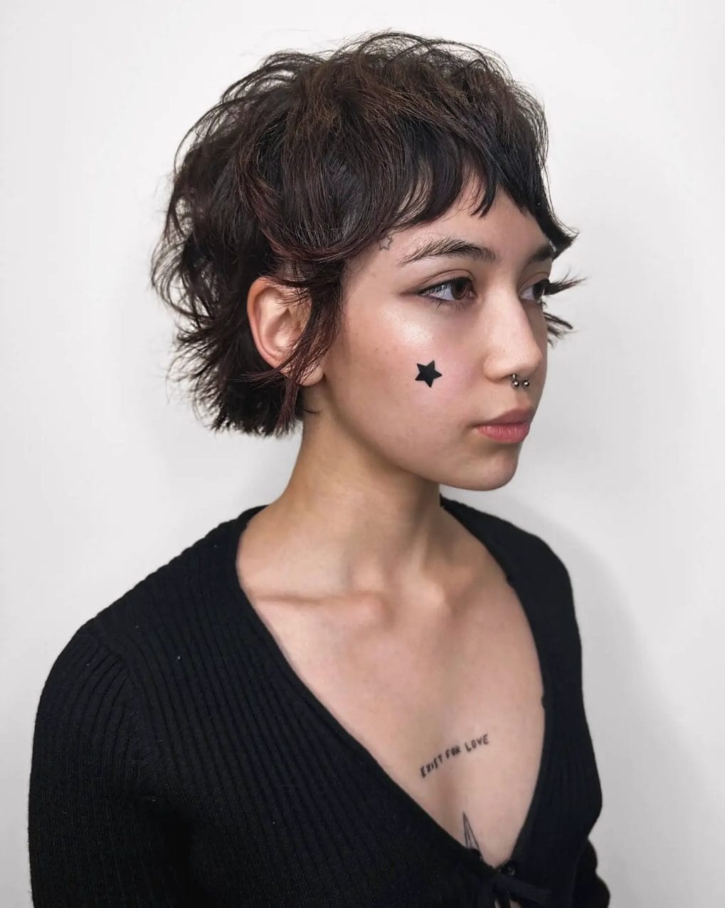 Playful, star-accented textured bob with natural waves and curtain bangs