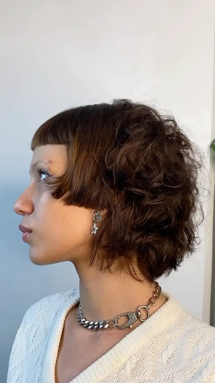 Asymmetrical bob with playful waves and side-swept bangs
