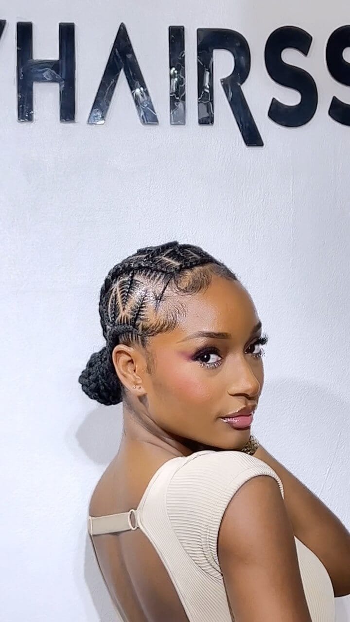 Sleek bun with intricate cornrow braids for a polished birthday hairstyle.
