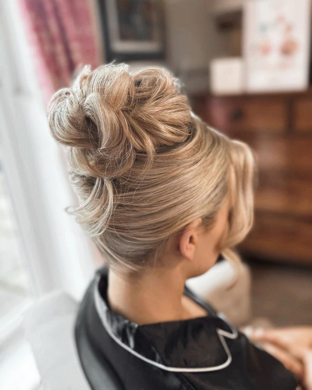 Polished high bun with twisted strands and honey highlights