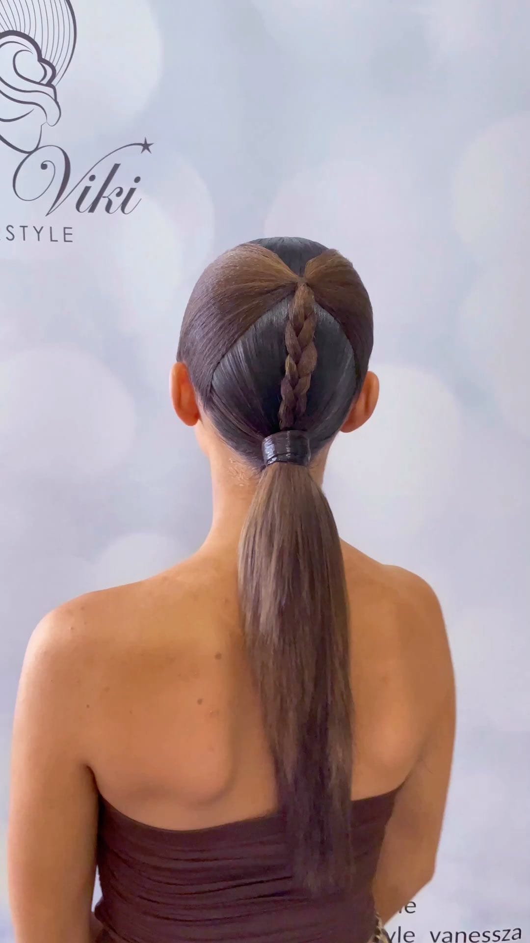 Neat ponytail with center braid adding a polished touch