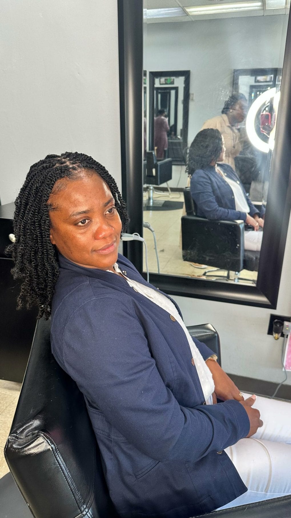 Shoulder-length kinky twists with a flattering side part for a professional look