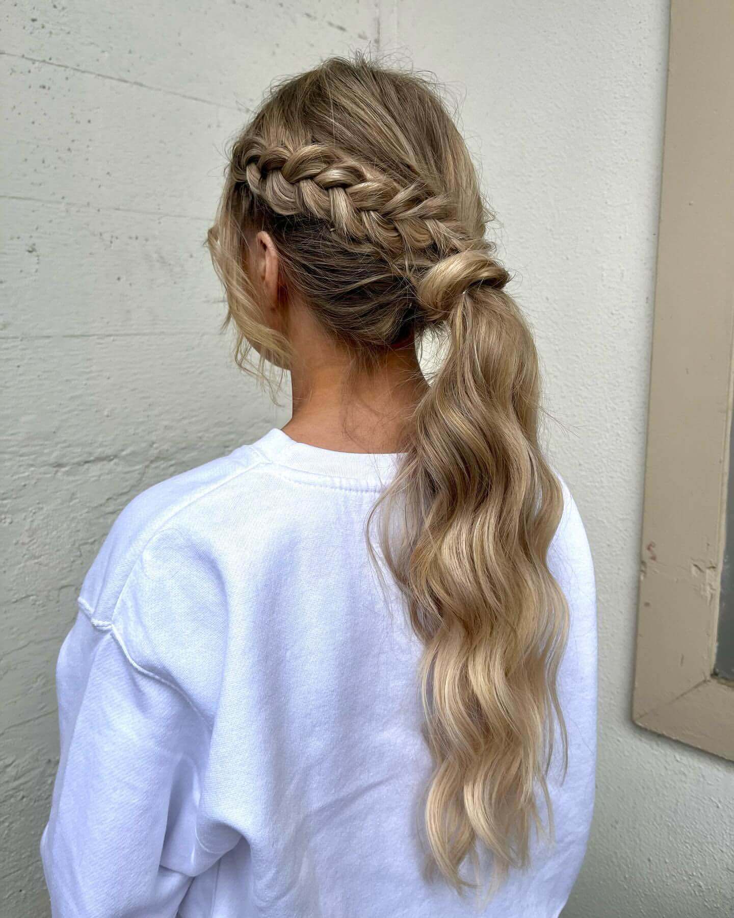 Blonde low ponytail with side braid and waves