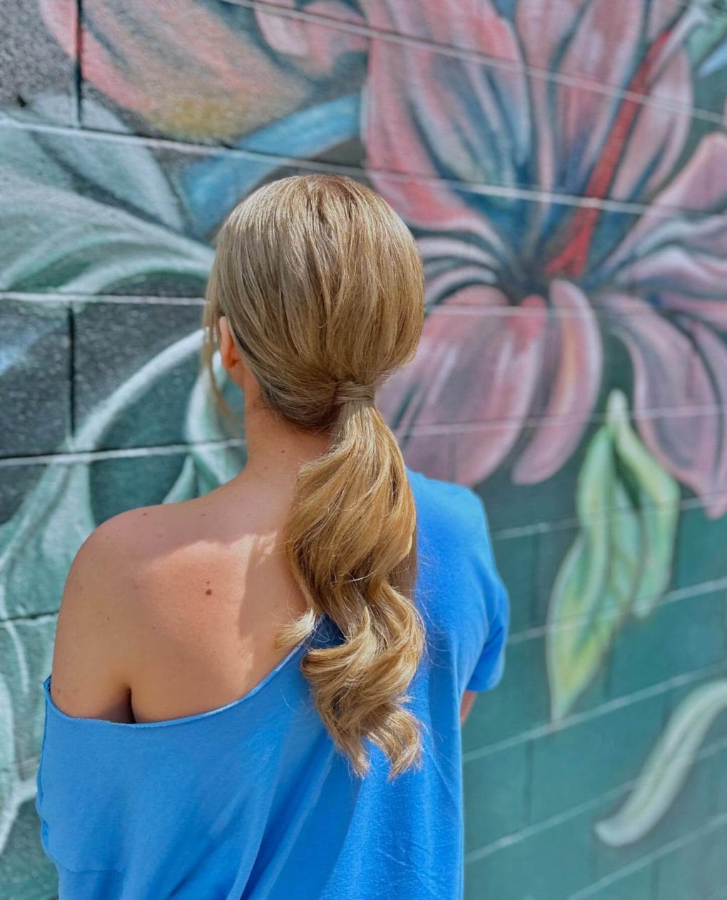 Low ponytail with gentle waves in light blonde shade
