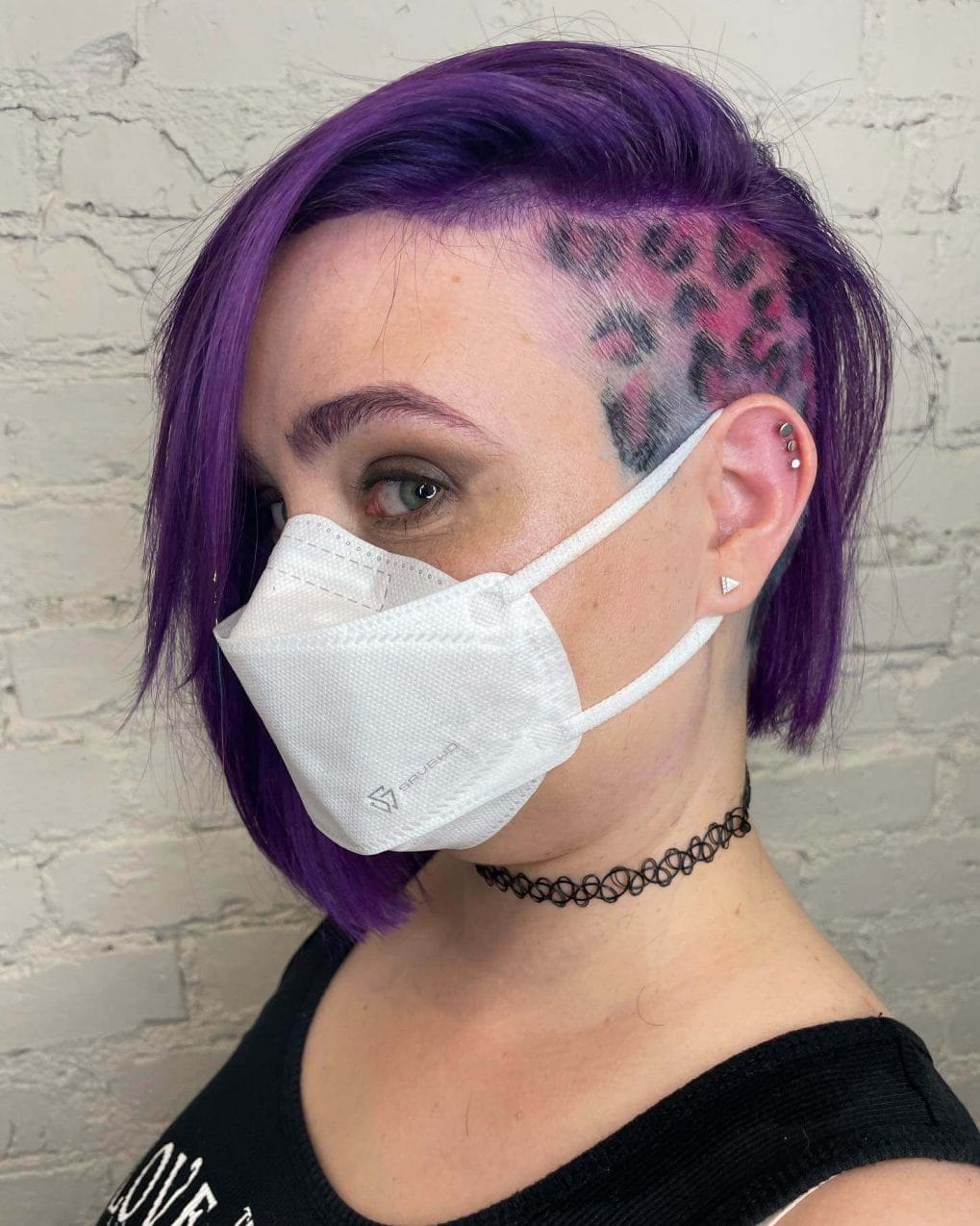 Rich purple bob with a playful leopard print design on the undercut, exhibiting a pop-art flair.
