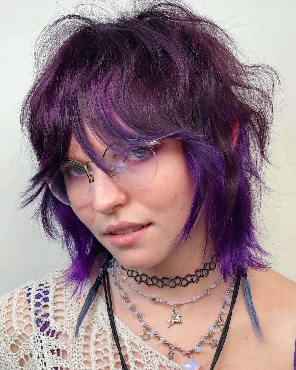 Cool purple shaggy bob with choppy bangs and textured layers