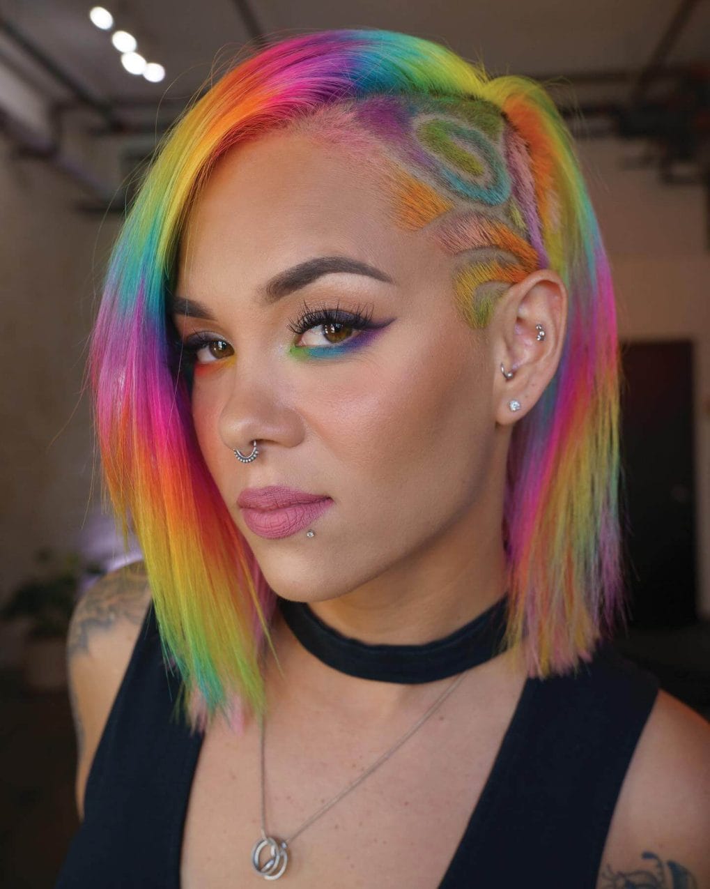 Sleek, chin-length bob with rainbow shades and a creative undercut design, perfect for festival flair.