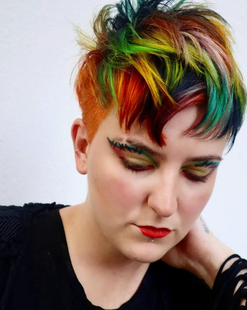 Pixie with colorful rainbow patchwork and a deep undercut.