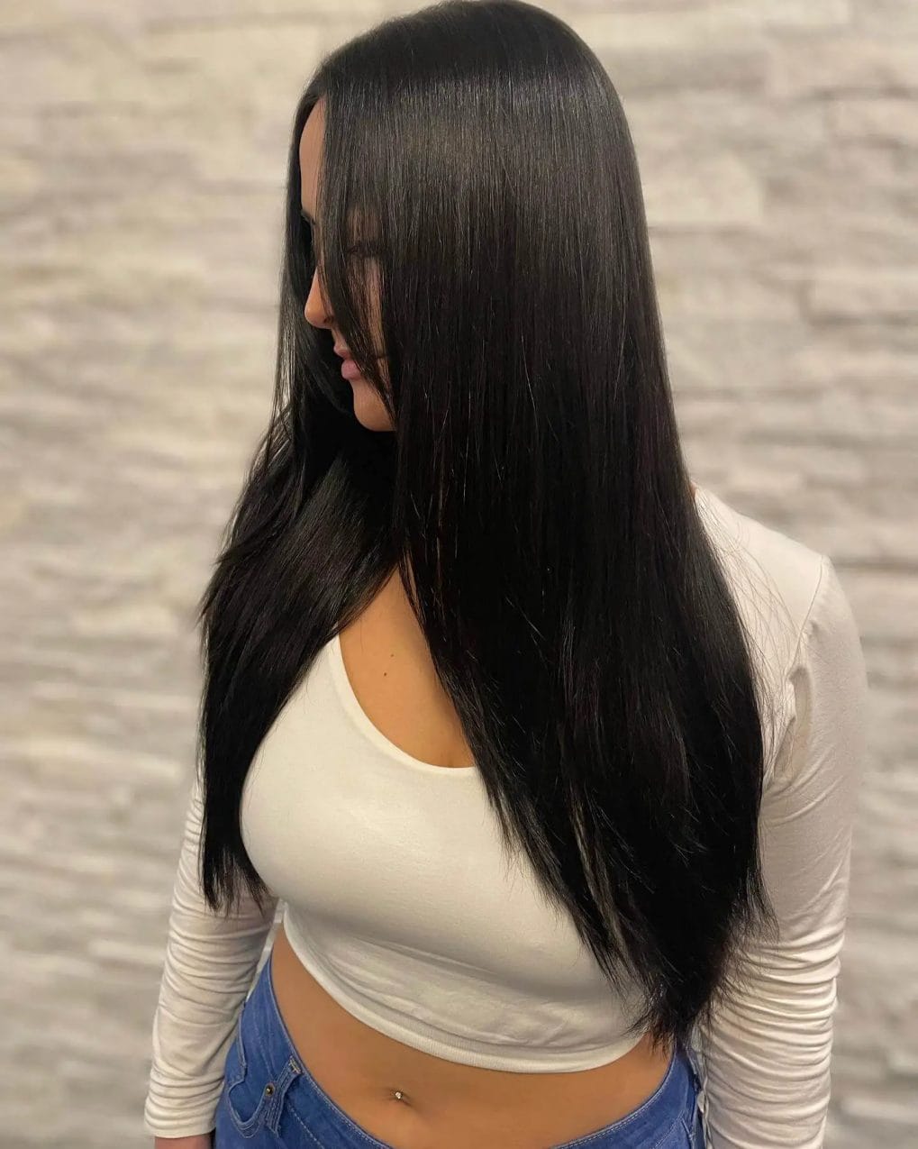 Refreshed dark brunette hair in a layered V-shaped cut.