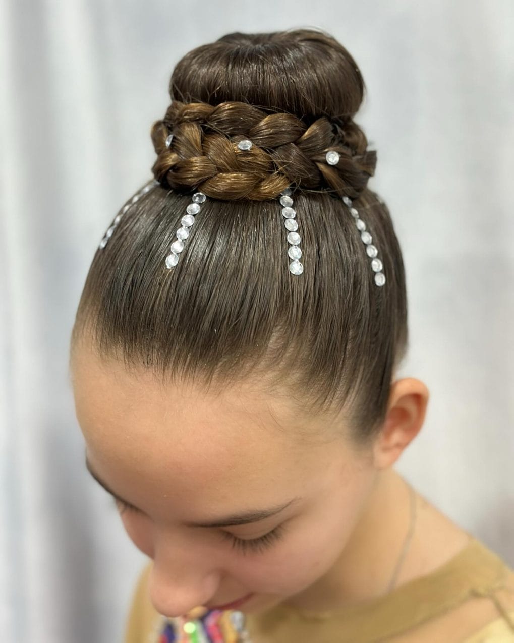 Regal braided crown high bun with silver gem accents