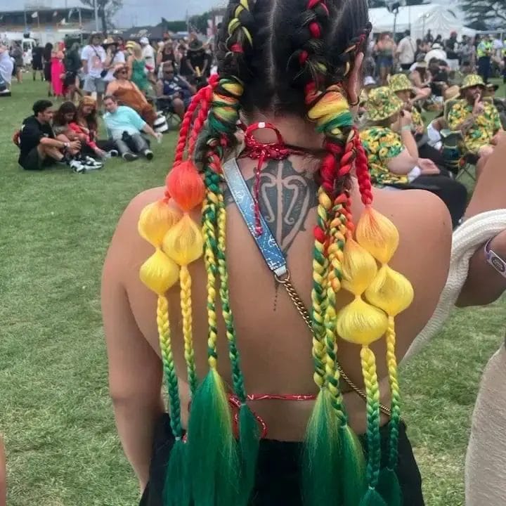 Red, yellow, and green braids with circular charm and yellow bulb accents