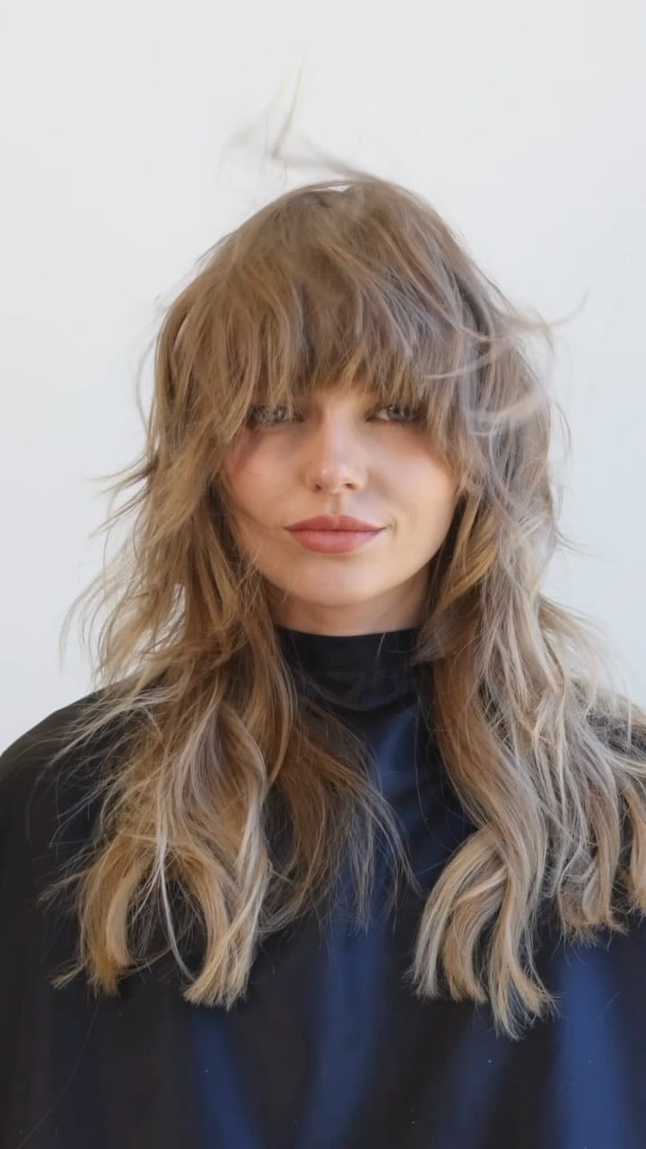 Relaxed wavy layered shaggy mullet with feathered, messy bangs