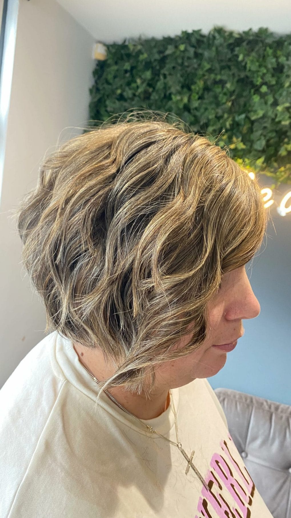 Relaxed wavy pixie bob with light and dark blonde highlights for a sun-kissed beachy feel