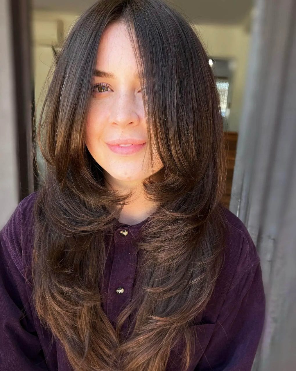 Brunette hair capturing the 90s essence with elegant layers.