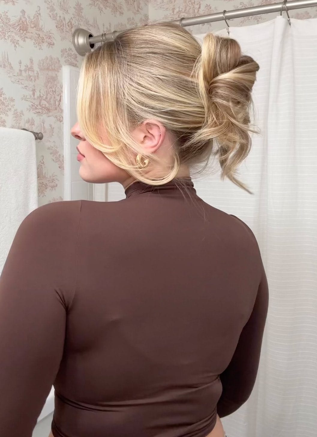 Playful romantic updo with loose strands for summer weddings