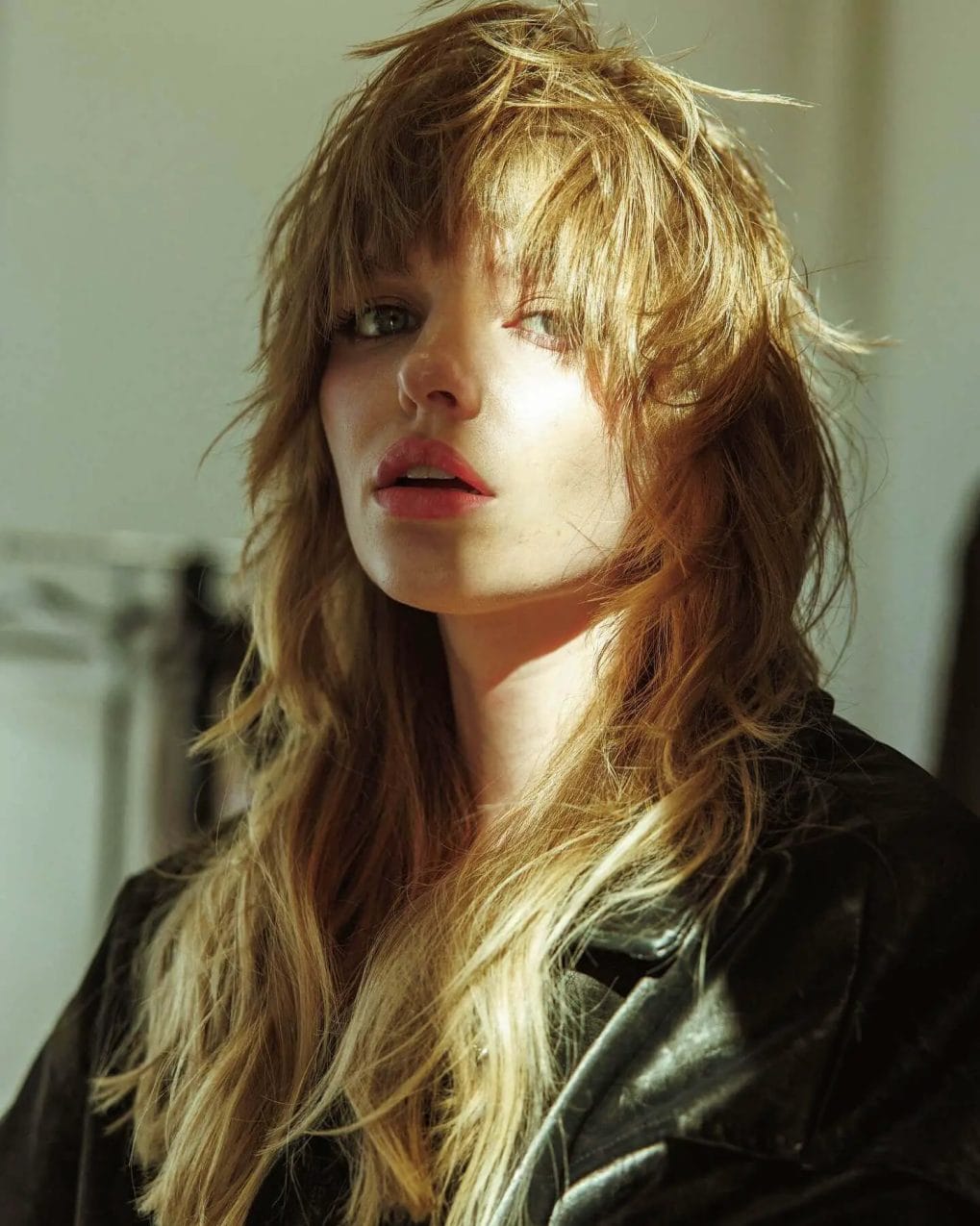 Messy-chic sandy blonde shaggy cut with long feathered bangs