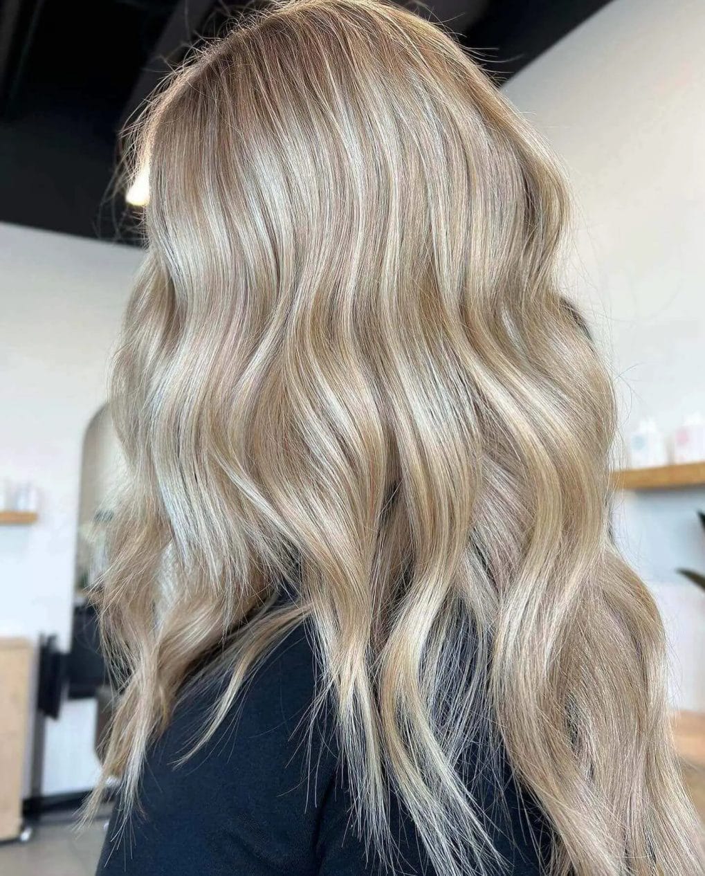 Soft sandy blonde with airy layers and pale ash highlights