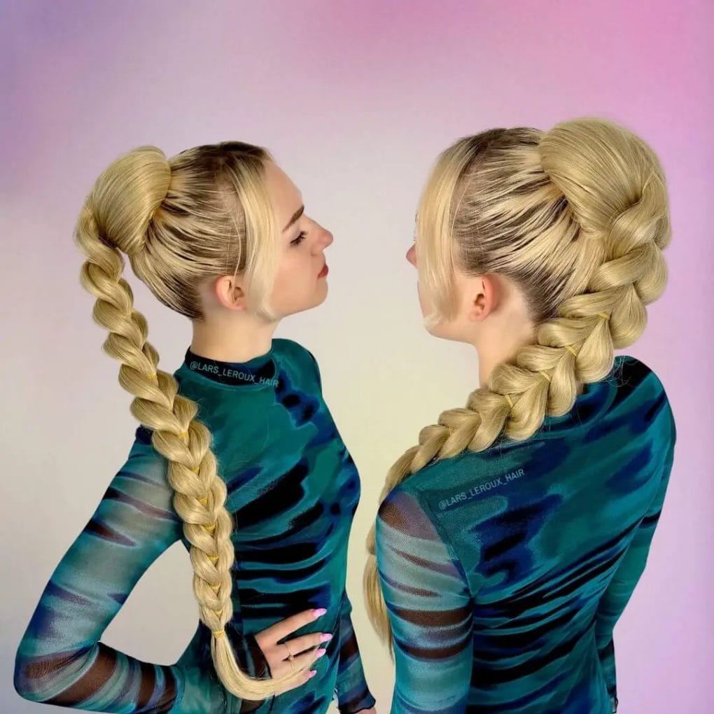 Strikingly sculpted, voluminous platinum blonde braided ponytail with architectural texture.