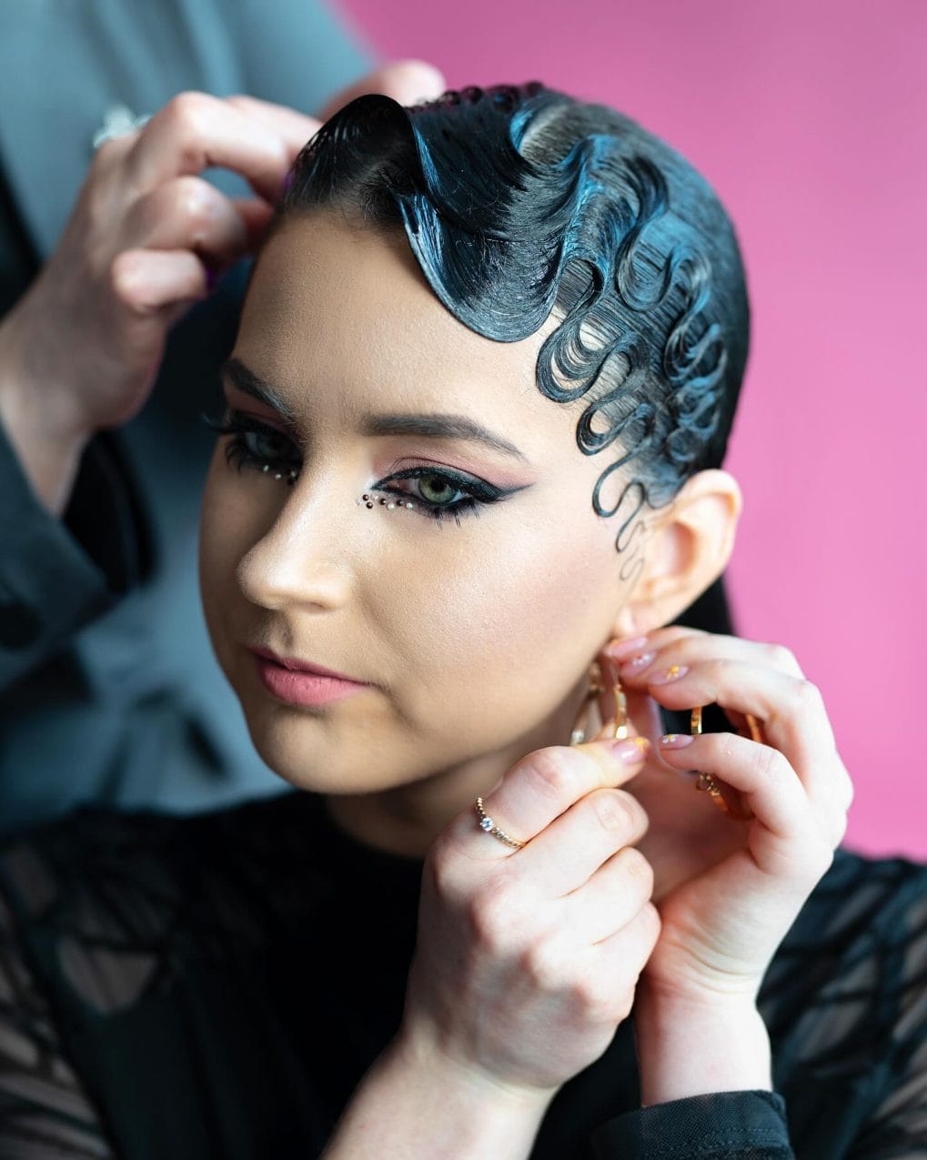 Sculpted shiny curls close to the head for stage glamour