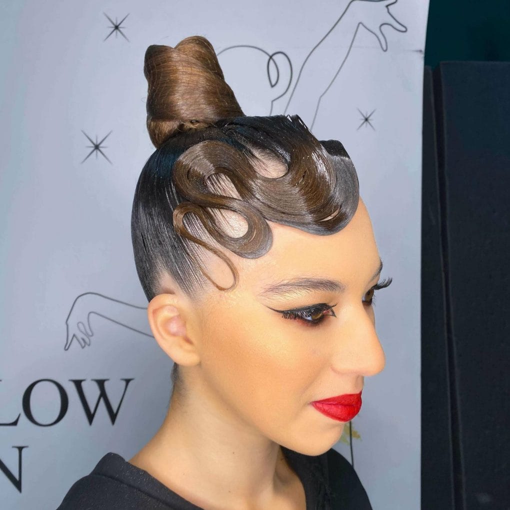 Sculpted waves with a towering bun for a modern look