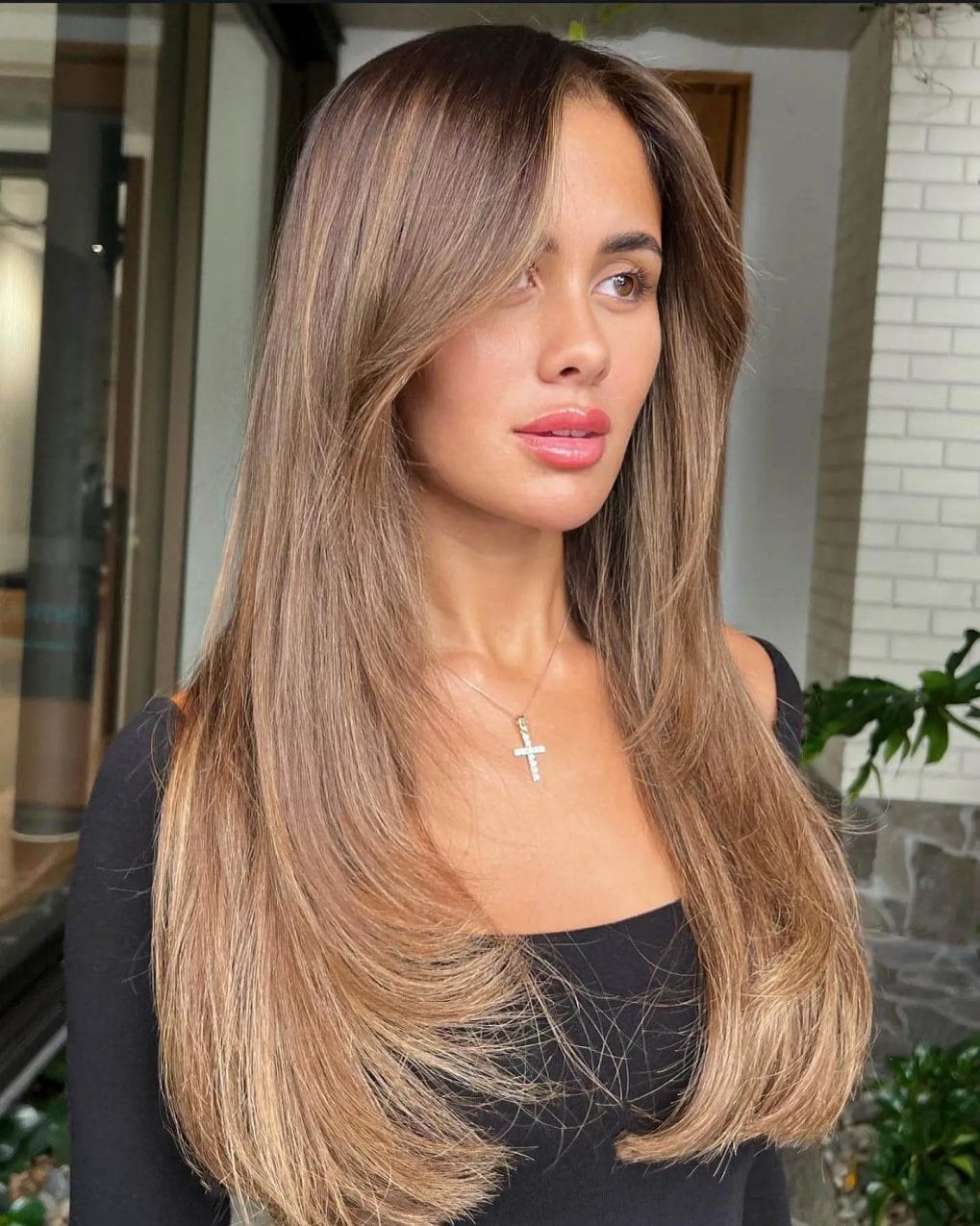 Flawless transition from brown to blonde in a seamless bronde hairstyle.