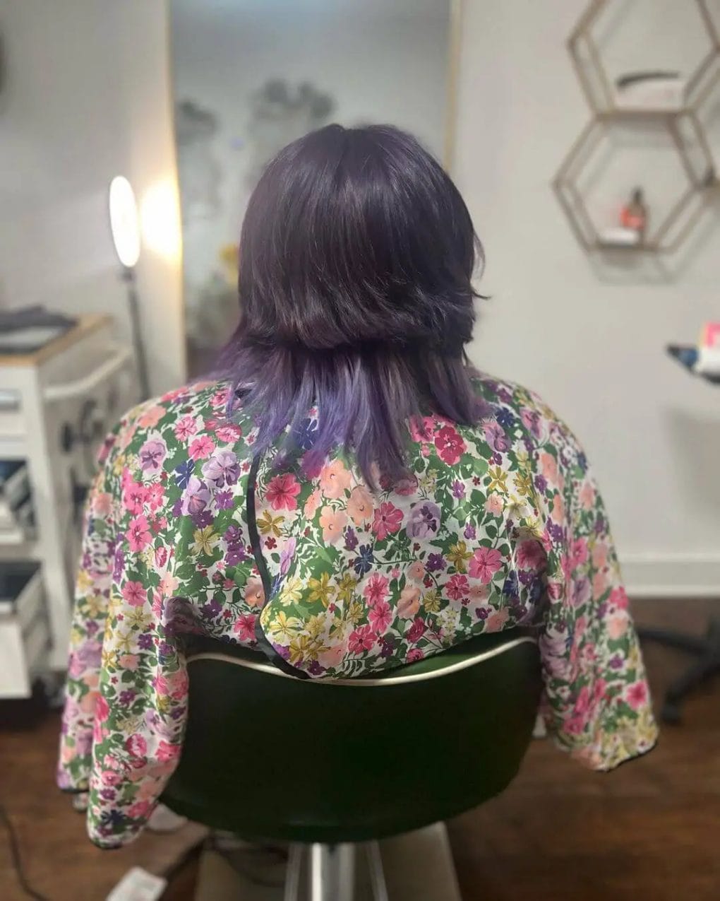 Serenely elegant jellyfish haircut with cascading dark purple layers and subtle waves.