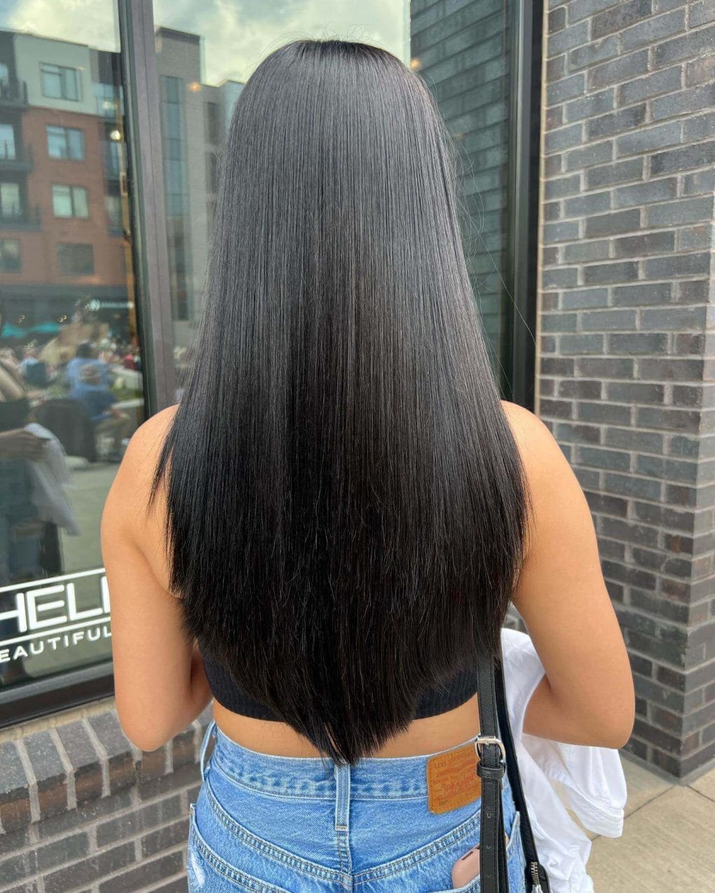 Shiny dark V-cut hair offering depth and dimension.