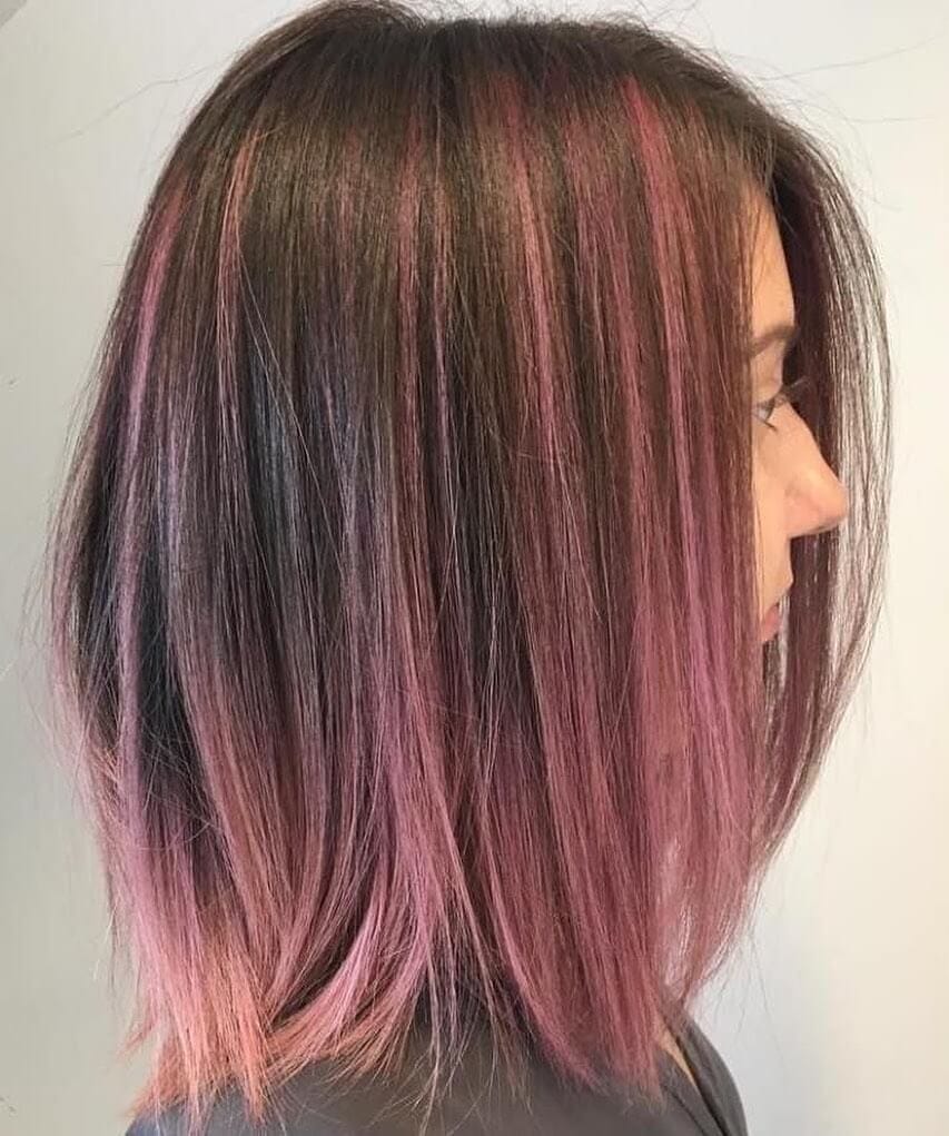 Chic ombre fusion of natural undertones with pops of pink at shoulder length.