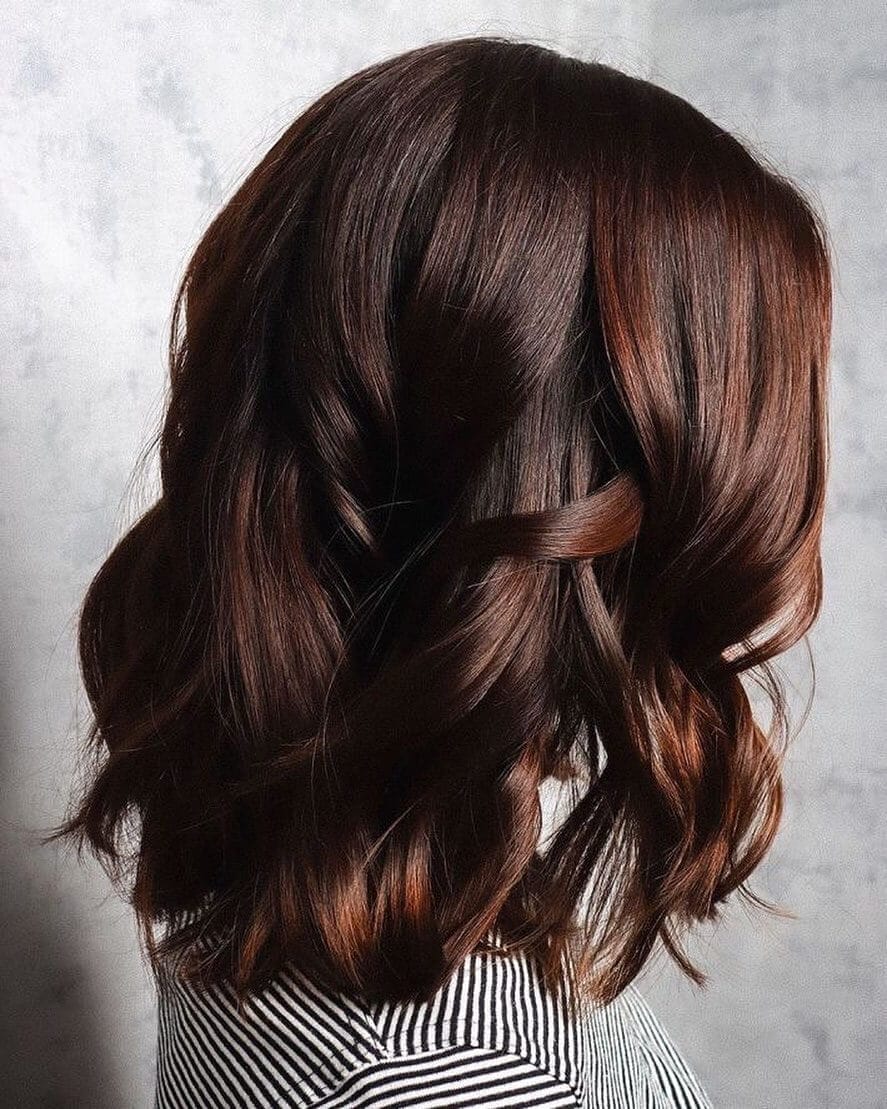 Mahogany shoulder-length waves with caramel highlights.