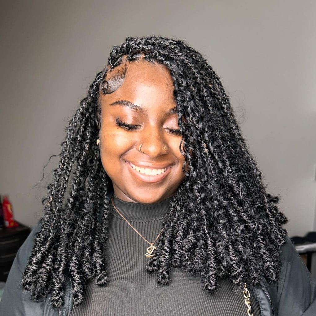 Neat shoulder-length kinky twists with waved baby hairs