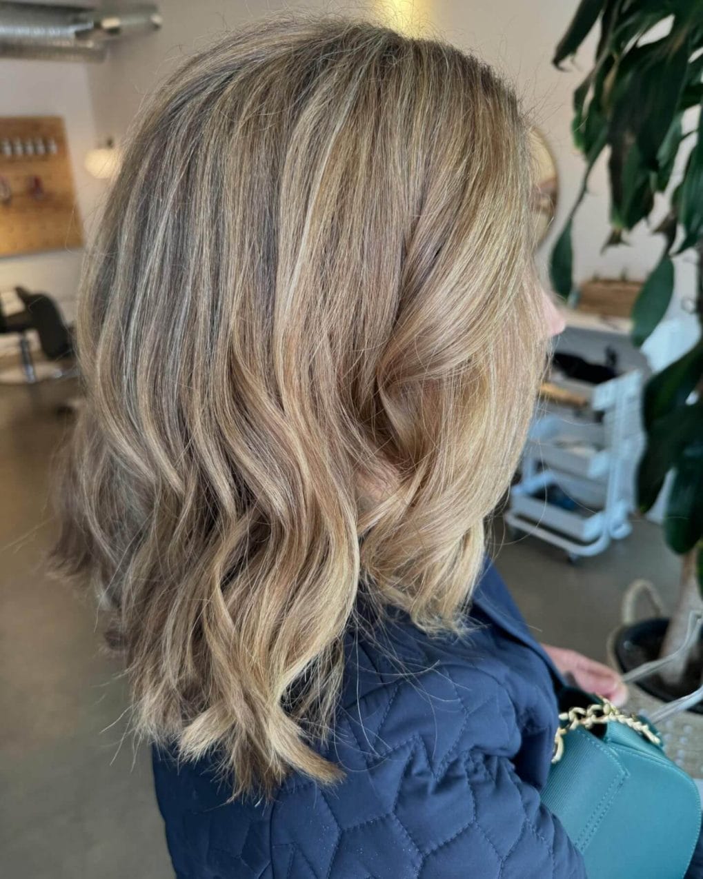 Shoulder-length wavy hair with sun-kissed blonde and brown balayage