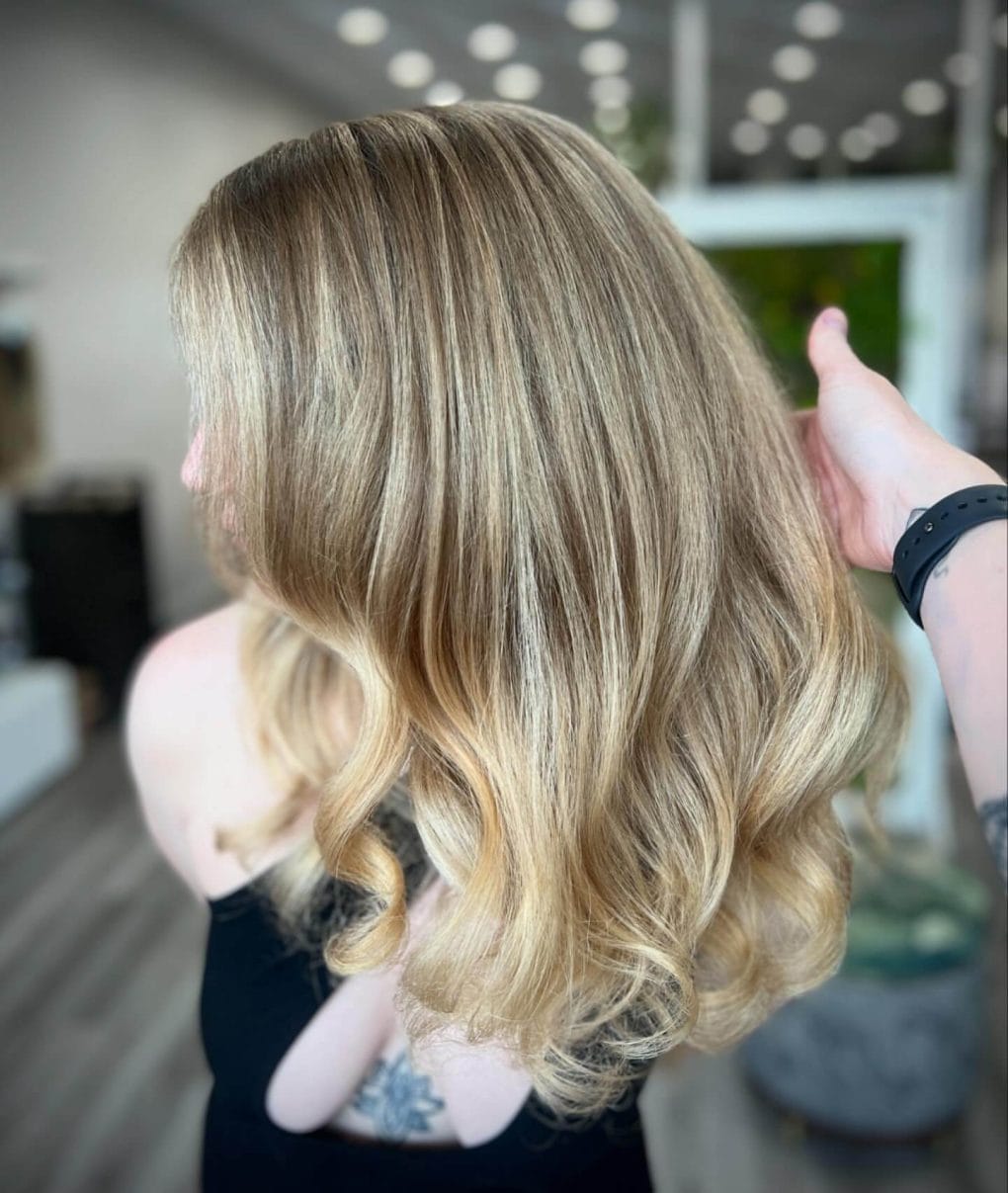 Shoulder-length wavy hair with warm blonde and light brown balayage
