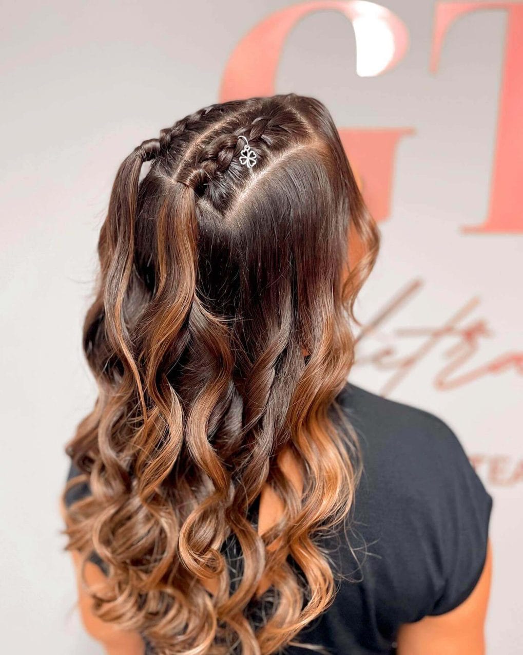 Side-swept braid twists into deep chocolate brown waves framing the face