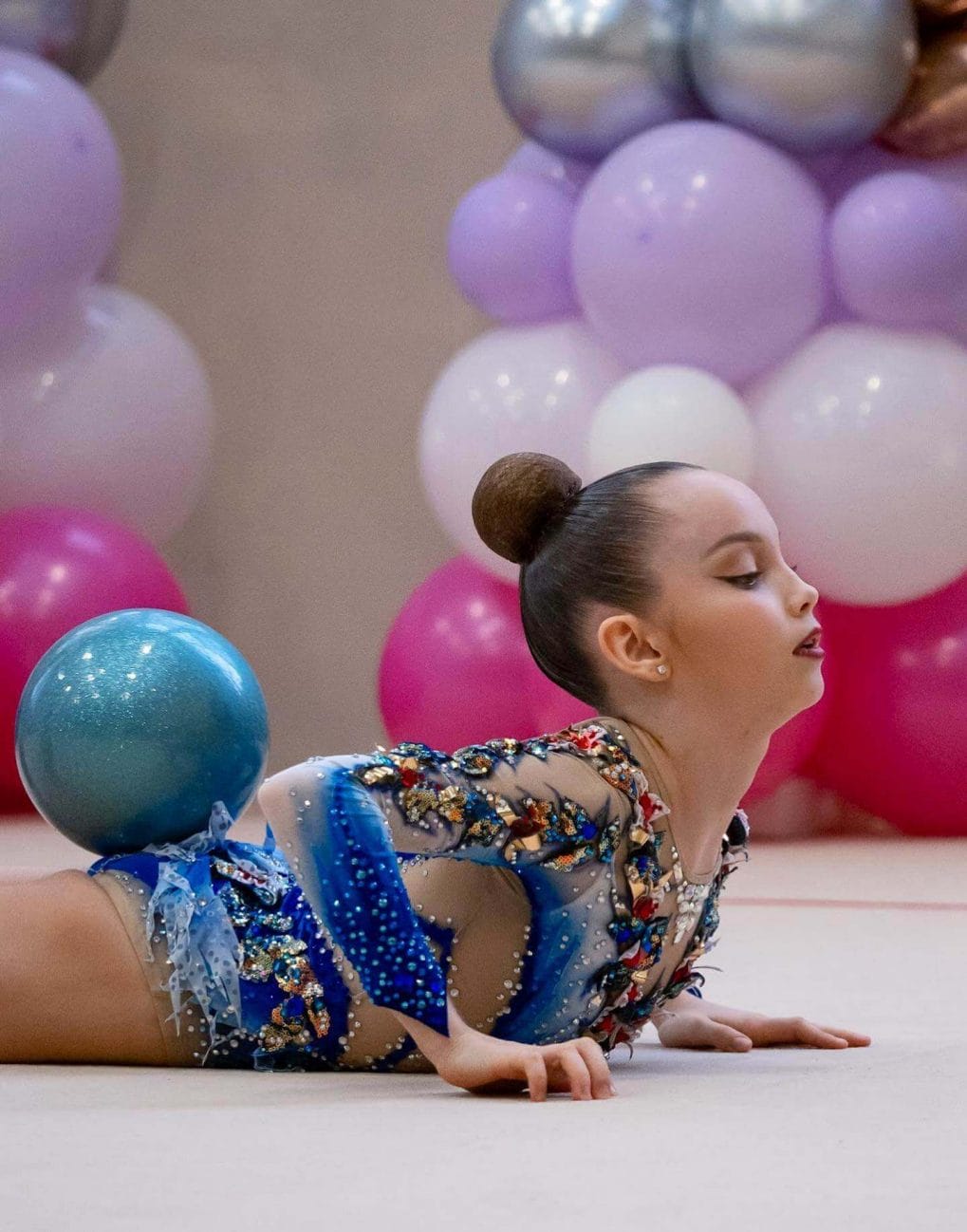 Simple, distraction-free bun keeping gymnasts focused on their routine, embodying cleanliness and precision