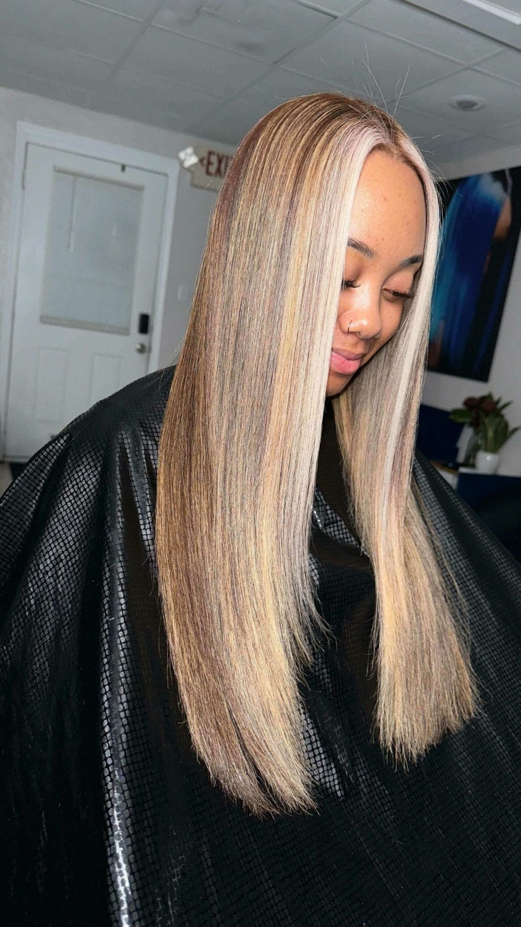 Long, silky straight silk press in trendy ash blonde, cut smoothly with no layers