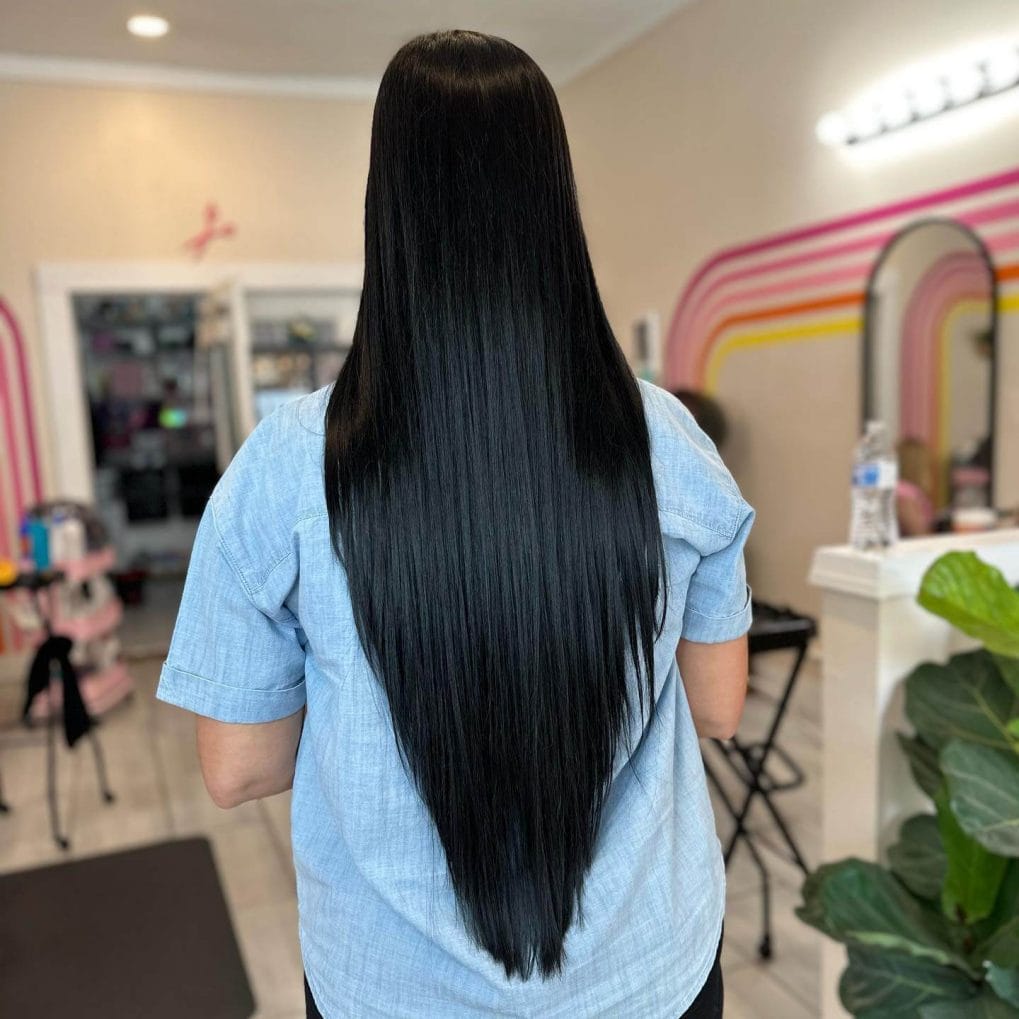 Intense black, straight hair styled in a sleek V-shape.