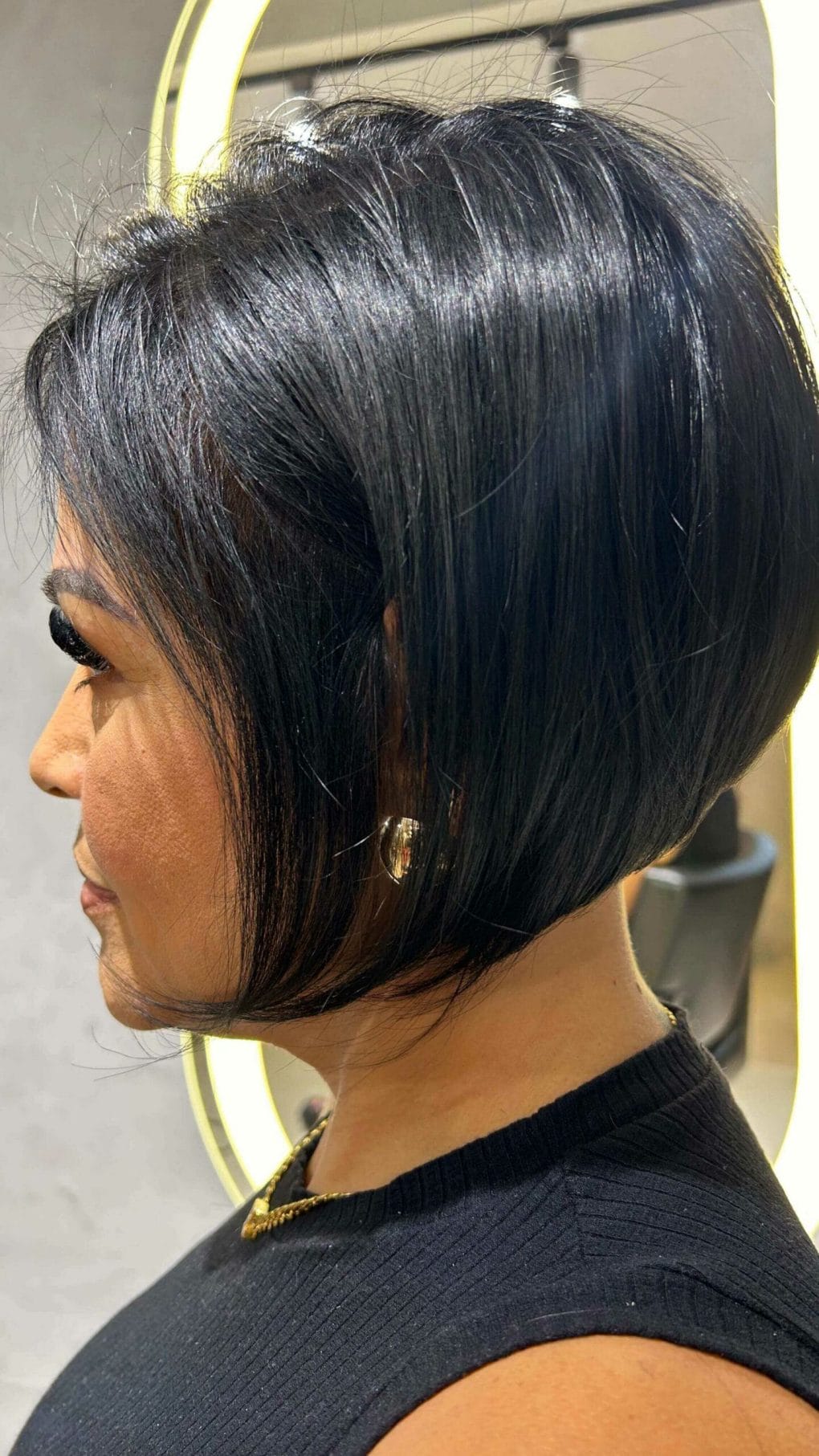 Short back sleek wedge with shiny black angled front