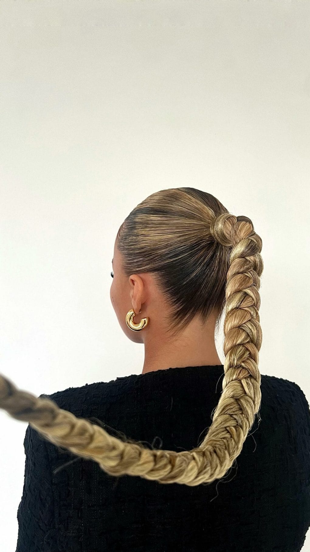 Sleek blonde ponytail evolving into a tight rope braid, ideal for intense workouts