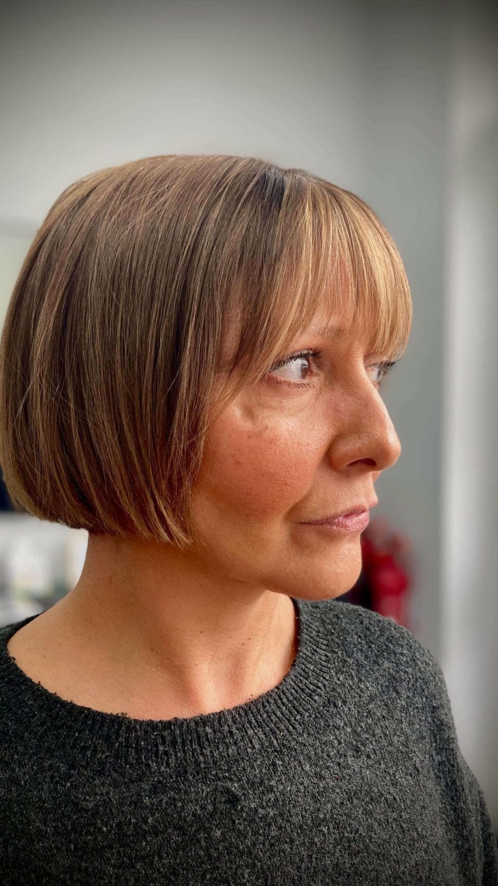 Brown French bob with sleek side-swept bangs