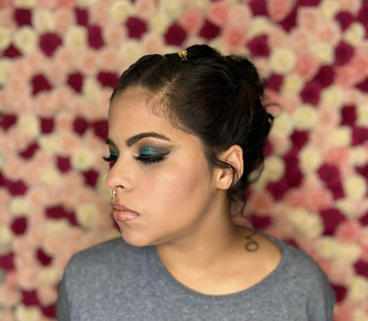 Sleek dark bun with soft tendrils