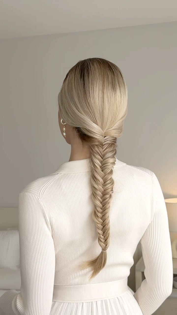 Sleek blonde fishtail braid starting high, secure for all gym activities
