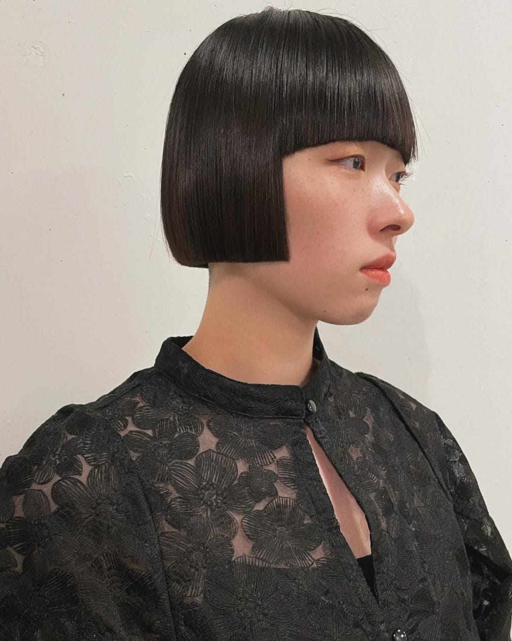 Sleek black geometric bob with straight-across fringe