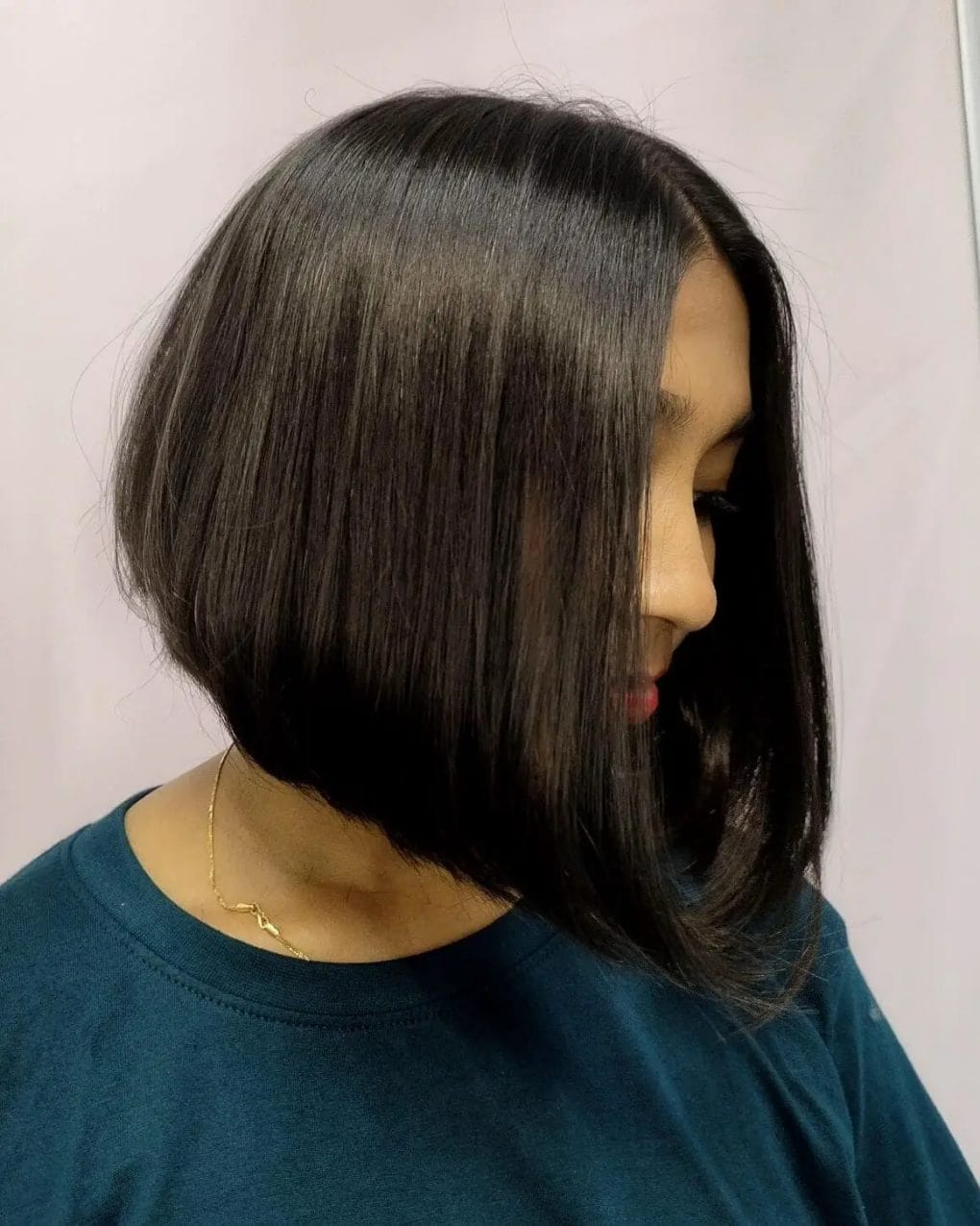 Sleek graduated bob with a glossy dark finish and precise styling.