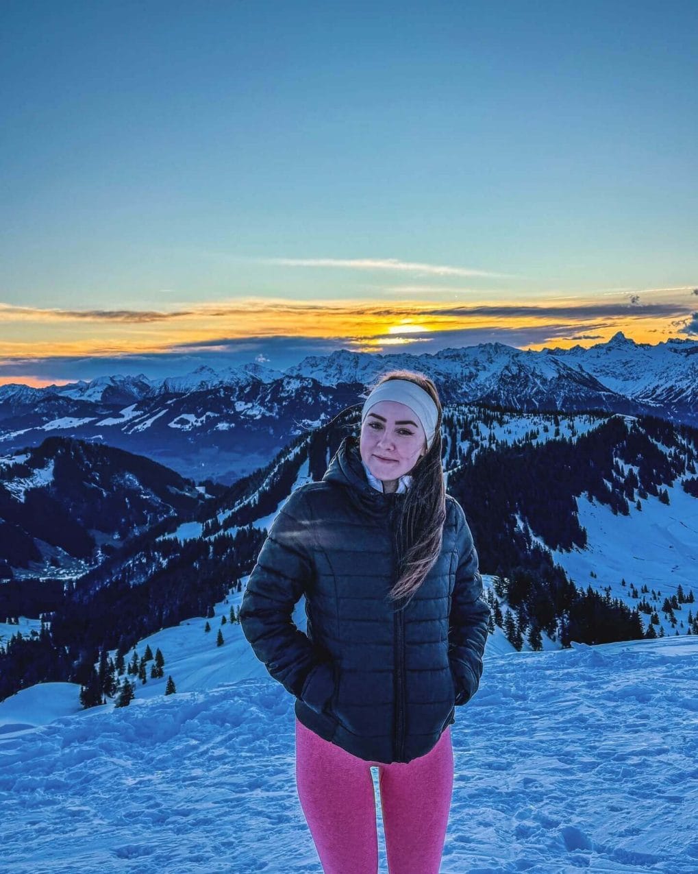 Hiker with straight hair and headband against a snowy backdrop