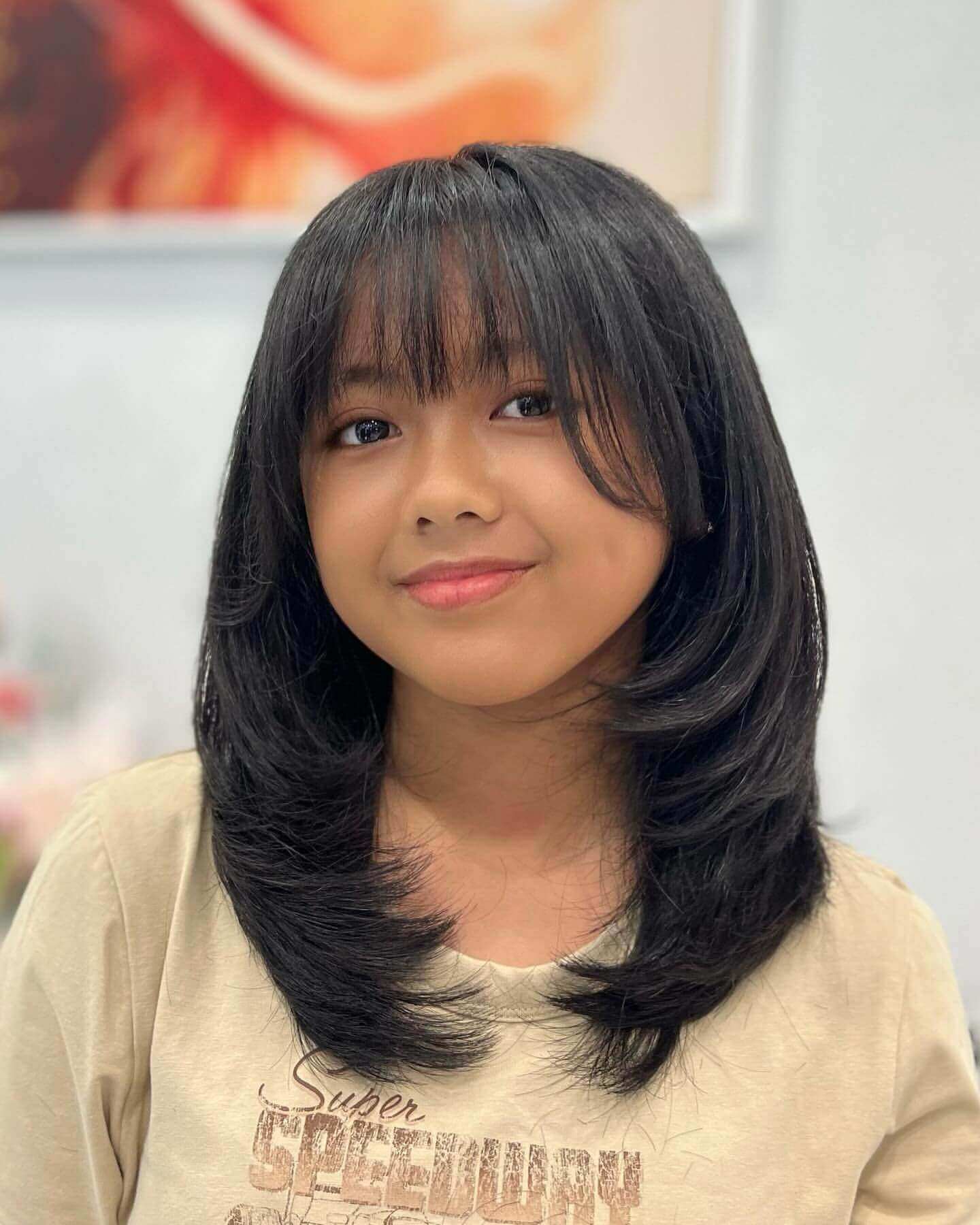Medium-length sleek layers with see-through bangs