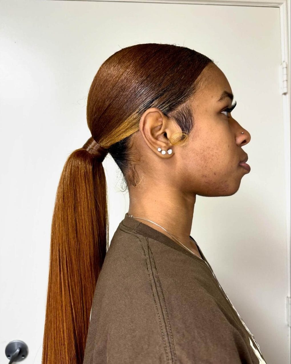 Cinnamon brown sleek ponytail for a minimalist and efficient volleyball hairstyle