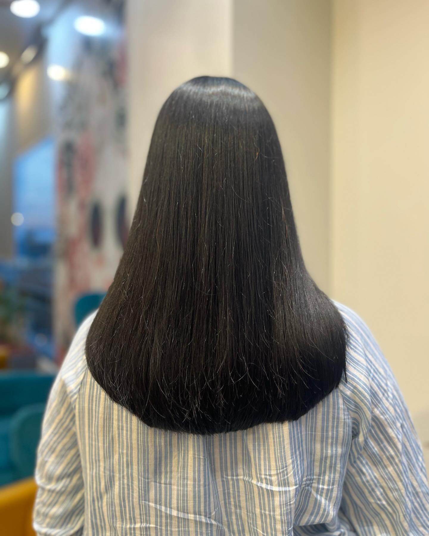Sleek raven-black U-cut with sharp, defined ends radiating depth and sheen.