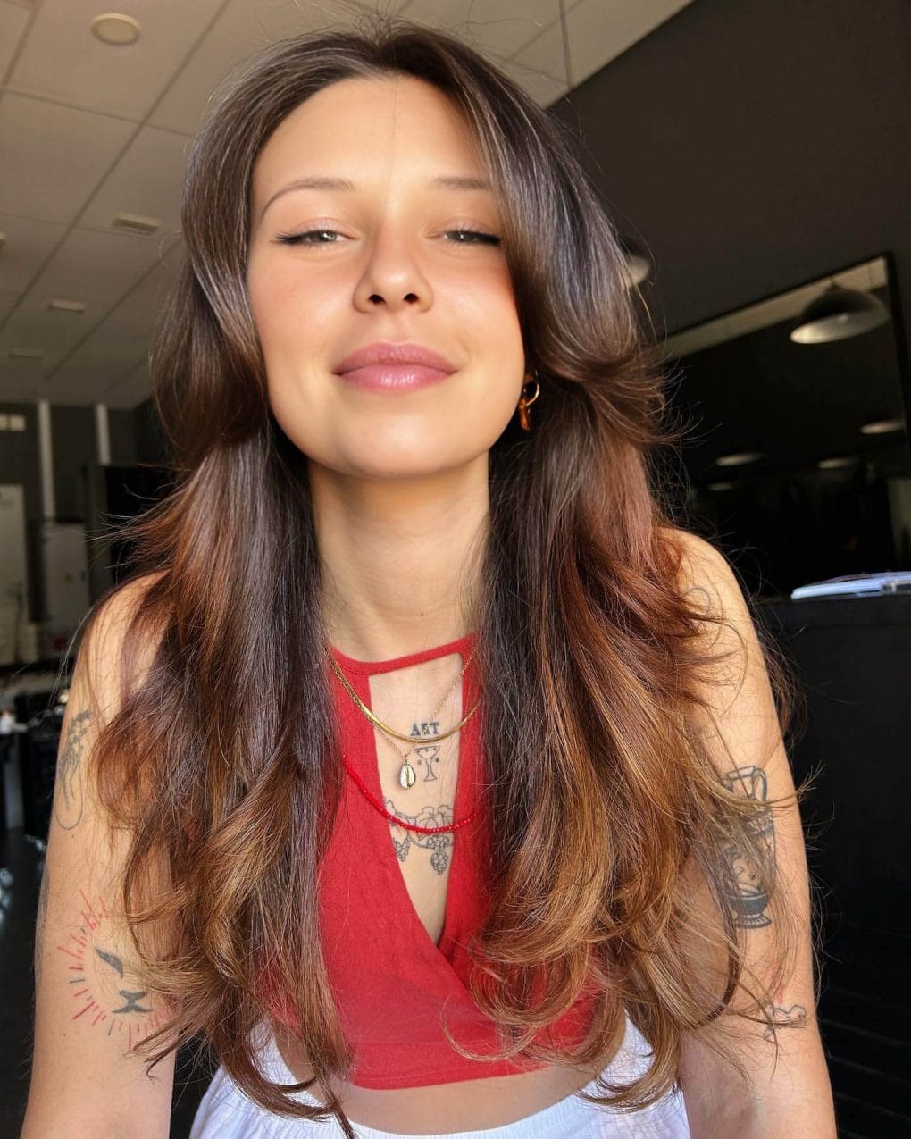 Butterfly Cut merging sleek strands with voluminous waves in an ombré transition.