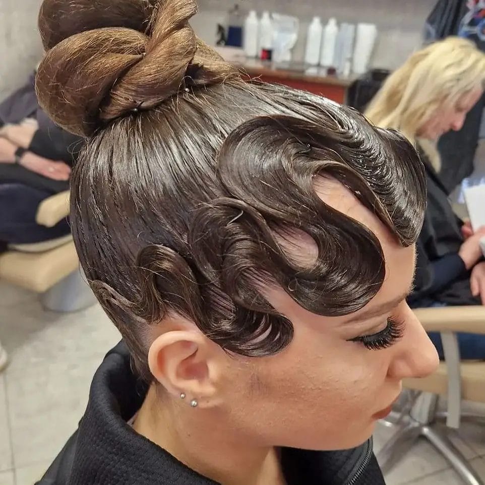 Sleek updo with precision waves framing the face